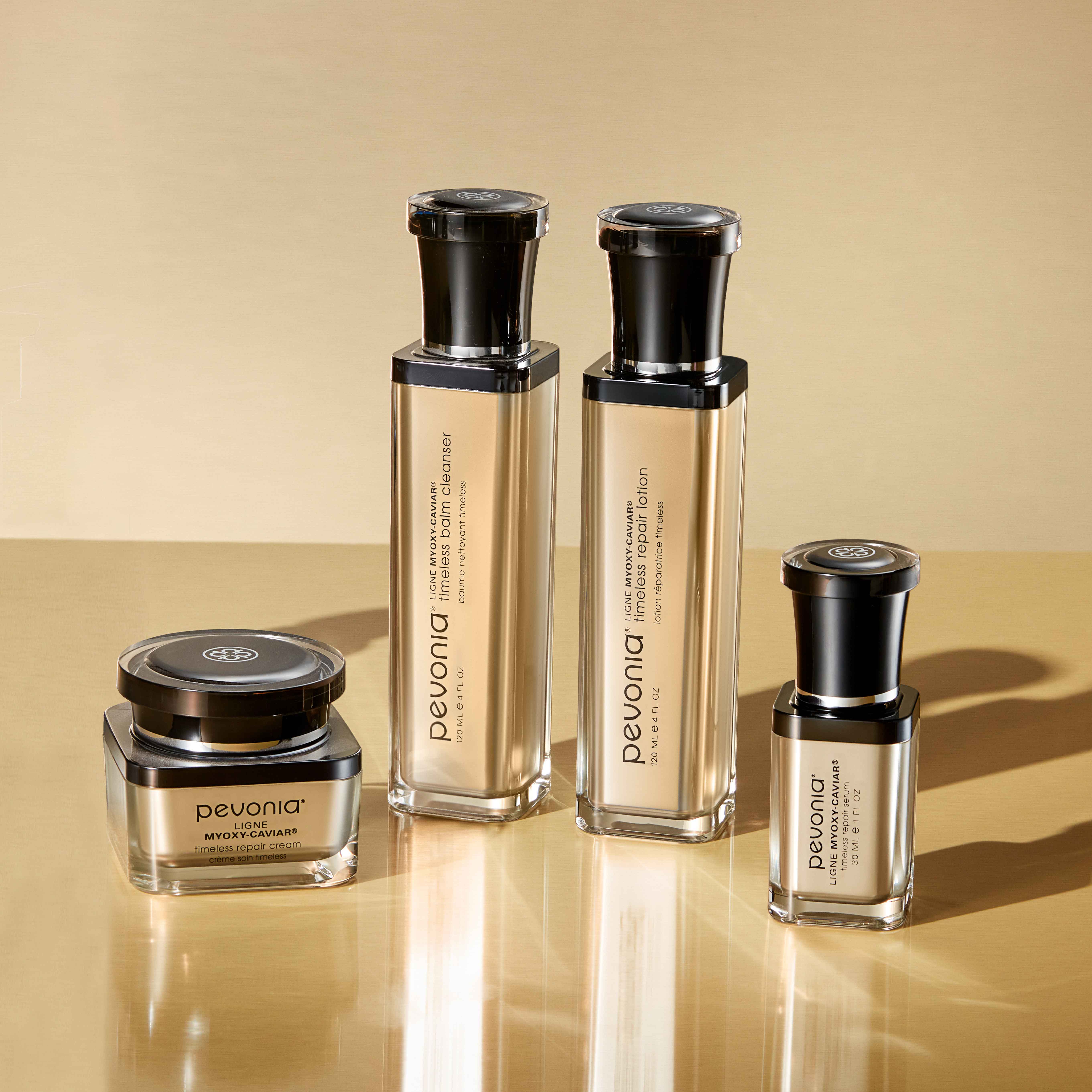 Myoxy-Caviar Line arranged on a shiny, reflective tan table.