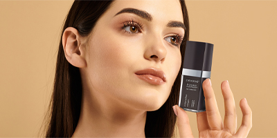Woman holding Pevonia's Intensifier - Collagen serum.